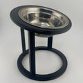Black raised cat feeder with circular base, side angle view, elevated cat bowl UK