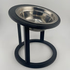 Black raised cat feeder with circular base, side angle view, elevated cat bowl UK